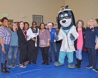 Members from the Youngstown City Health District who volunteered at the "Citywide Baby Shower" at the Eugenia Atkinson Recreational Center Saturday, April 7, 2018, pose with "Dr. Health E. Hound" at the event's close.  From left to right, they are: Andrea Bivens-Flakes, Erin Bishop, Faith Terreri, Leigh Green, Golie Stennis, Michelle Thomas, Richard Dezsi, "Dr. Health E. Hound," Paula Lewis, and Sandra Pazanavich.

Photo by Scott Williams - The Vindicator