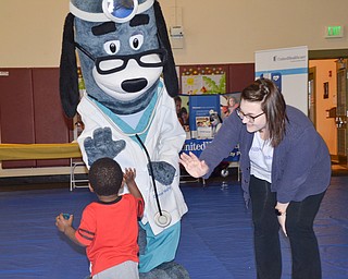 Kaylee Kapalko, Canfield, from United Health Care, and "Dr. Health E. Hound" greet some of the children who were in attendance of the "Citywide Baby Shower" at the Eugenia Atkinson Recreational Center Saturday, April 7, 2018.

Photo by Scott Williams - The Vindicator