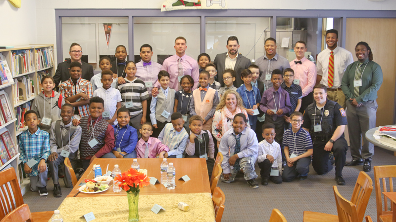 A group of Youngstown State University men come to Williamson Elementary School on Youngstown’s South Side twice monthly for a “gentlemen’s” meet and lunch event with male students. The idea is to provide positive male role models for young boys and teach them proper etiquette.