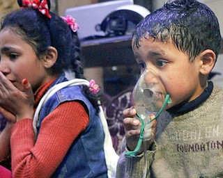 This image released early Sunday, April 8, 2018 by the Syrian Civil Defense White Helmets, shows a child receiving oxygen through respirators following an alleged poison gas attack in the rebel-held town of Douma, near Damascus, Syria. Syrian rescuers and medics said the attack on Douma killed at least 40 people. The Syrian government denied the allegations, which could not be independently verified. The alleged attack in Douma occurred Saturday night amid a resumed offensive by Syrian government forces after the collapse of a truce. 

(Syrian Civil Defense White Helmets via AP)