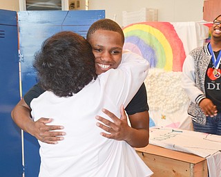 Ms. Jeanne Constantino, advisor of the Destination Imagination group at East East School, gives Kaysonn Madison, 10th grade, a huge after he said she was, "The best advisor ever." on Monday, April 9, 2018. Marquan Stevenson, 11th grade, is in the background.

Photo by Scott Williams - The Vindicator