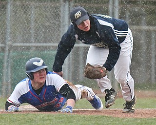 William D. Lewis The Vindicator Western Reserve Seth Phillips(25) is out at 3rd as Lowellville's Bryan Harris(22) makes the tag during snowy 4-9-18 game at Cene.