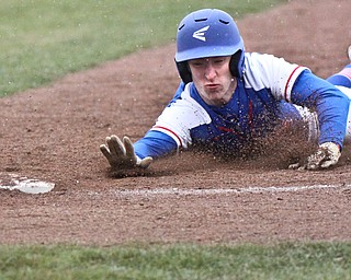 William D. Lewis The Vindicator Western ReserveRyan Slaven(7) dives back to first during snowy 4-9-18 game at Cene with Lowellville.