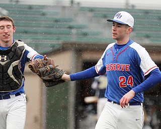 William D. Lewis The Vindicator Western Reserve pitcher Dom Velasquez bumps gloves with catcher Ryan Slaven(7)during snowy 4-9-18 game at Cene with Lowellville.