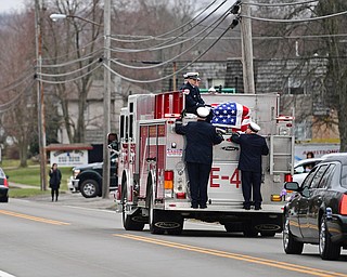 WEATHERSFIELD, OHIO - APRIL 9, 2018: A Weathersfield fire truck transporting Weathersfield Township Fire Chief Randall Pugh's casket drives on Route 46, after the conclusion of his funeral, Monday morning. DAVID DERMER | THE VINDICATOR