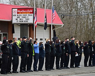 WEATHERSFIELD, OHIO - APRIL 9, 2018:Firemen and women stand and salute as the funeral procession for Weathersfield fire truck transporting Weathersfield Township Fire Chief Randall Pugh passes in front of the Weathersfield Township fire station, Monday morning. DAVID DERMER | THE VINDICATOR