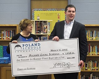 Neighbors | Zack Shively.Representatives from the Poland Schools Fund and the Poland schools met in Dobbins Elementary's library for a check presentation. One check went toward the robotics and STEM program at the school. The funding was raised through a car raffle in 2017.