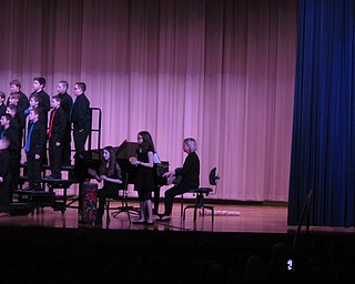 Neighbors | Zack Shively.Choir teacher Megan Keown challenged the students with tough songs, some of which had three parts. Pictured, the students sang a song in Swahili while two students played rhythmic instruments.