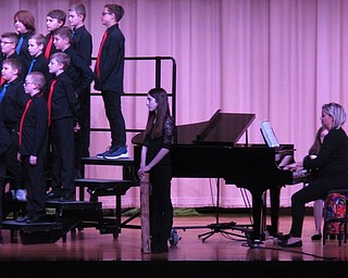 Neighbors | Zack Shively.The choir welcomed different accompaniments during their concert. Many songs had a piano feature, some had a drum beat and one used a rainstick. Pictured, a student played the rainstick during "How Beautiful is the Rain?"