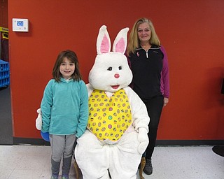 Neighbors | Zack Shively.Austintown Bounce gave each child a bag of treats upon entering and gave them a chance to take pictures with the Easter Bunny at their Easter Eggstravaganza. Pictured are Natalie Faraglia, the bunny and Kim Parent.