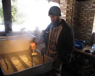 Neighbors | Zack Shively.The Maple Syrup Festival featured a presentation of how maple syrup is made at Boardman Park's sugar shack. Pictured is Gabe Manginelli using the park's evaporator to make syrup.