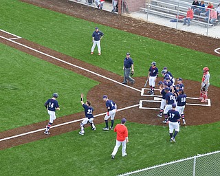 Austintown Fitch's #21, Mike Grazier, waves home #14, Nick Belcik, after hitting the very first home run at the new Richard L. Coppola Field in Austintown on Thursday, April 12, 2018 against Columbiana.  Belcik would go on to hit a grand-slam over the fence before the end of the game.

Photo by Scott Williams - The Vindicator