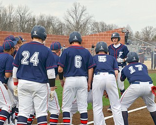 Austintown Fitch's #14, Nick Belcik, is about to be pummeled by his teammates after hitting a grand-slam against Columbiana at the home opener of the new Richard L. Coppola Field in Austintown on Thursday, April 12, 2018.

Photo by Scott Williams - The Vindicator