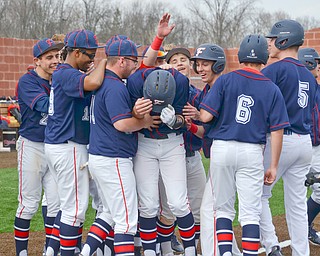 Austintown Fitch's #14, Nick Belcik, (center) is pummeled by his teammates after hitting a grand-slam against Columbiana at the home opener of the new Richard L. Coppola Field in Austintown on Thursday, April 12, 2018.

Photo by Scott Williams - The Vindicator