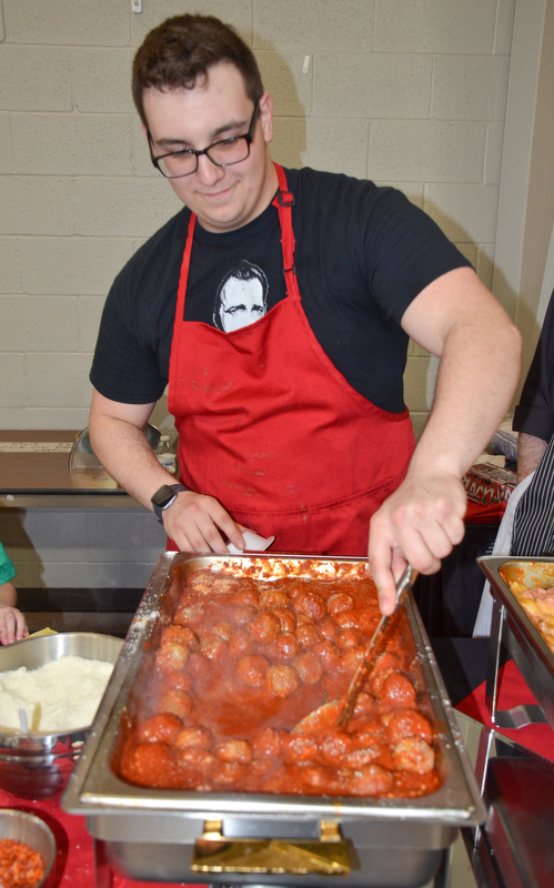 Nick Mozingo, from Bogey's Bar and Grill, stirs the meatballs that they were sampling at the annual "Taste of Struthers" event held at St. Nicholas in Struthers on Thursday April 12, 2018.

Photo by Scott Williams - The Vindicator