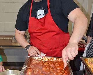 Nick Mozingo, from Bogey's Bar and Grill, stirs the meatballs that they were sampling at the annual "Taste of Struthers" event held at St. Nicholas in Struthers on Thursday April 12, 2018.

Photo by Scott Williams - The Vindicator