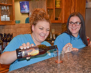 Sisters Danielle Bodnar, left, and Gina Ginnetti happily pour drinks at the bar at the annual "Taste of Struthers" event held at St. Nicholas in Struthers on Thursday April 12, 2018.

Photo by Scott Williams - The Vindicator