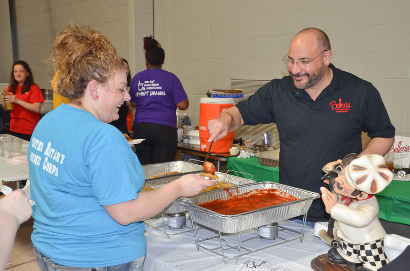 Frank Lellio, right, serves up some of Belleria's finest to Danielle Bodnar at the annual "Taste of Struthers" event held at St. Nicholas in Struthers on Thursday April 12, 2018.

Photo by Scott Williams - The Vindicator