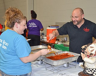 Frank Lellio, right, serves up some of Belleria's finest to Danielle Bodnar at the annual "Taste of Struthers" event held at St. Nicholas in Struthers on Thursday April 12, 2018.

Photo by Scott Williams - The Vindicator