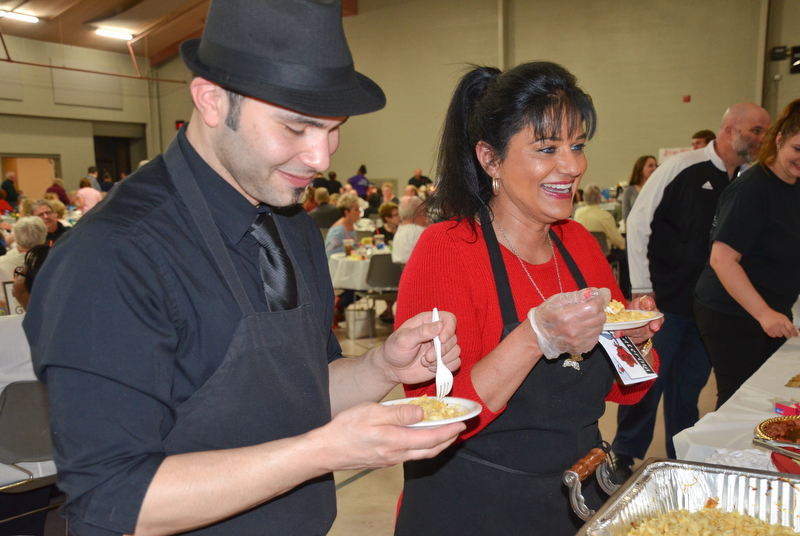 Angel Febres, left, and Theresa Tanferno, two employees from the Selah Restaurant in Struthers, sample haluski from Monica's Catering at the annual "Taste of Struthers" event held at St. Nicholas in Struthers on Thursday April 12, 2018.

Photo by Scott Williams - The Vindicator