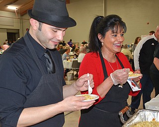 Angel Febres, left, and Theresa Tanferno, two employees from the Selah Restaurant in Struthers, sample haluski from Monica's Catering at the annual "Taste of Struthers" event held at St. Nicholas in Struthers on Thursday April 12, 2018.

Photo by Scott Williams - The Vindicator