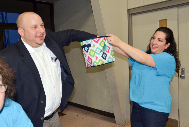 Struthers Municipal Court Judge Dominic Leone, left, pulls a winning 50/50 ticket from Catherine Cercone Miller's basket at the annual "Taste of Struthers" event held at St. Nicholas in Struthers on Thursday April 12, 2018.

Photo by Scott Williams - The Vindicator