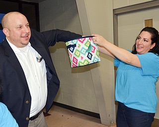 Struthers Municipal Court Judge Dominic Leone, left, pulls a winning 50/50 ticket from Catherine Cercone Miller's basket at the annual "Taste of Struthers" event held at St. Nicholas in Struthers on Thursday April 12, 2018.

Photo by Scott Williams - The Vindicator