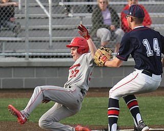 Columbiana's Hunter Znter (27) scores as Fitch's Nick Belcik tries to cover at the plate during 4-12-18 action at Fitch.

William D. Lewis - The Vindicator