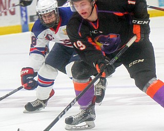 William D. Lewis The Vindicator Phantoms Chase Gresock(19) and USA's Domenick Fensore(38) go for the puck during 4-12-18 at Covelli. Students from area schools visited the Covelli for a hockey game.