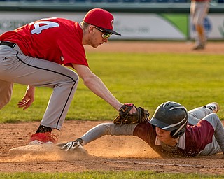 Liberty baserunner Shane McKelvey dives back to first base to avoid a pick off by Girard first baseman Shawn Leasure during their game at Eastwood Field on Friday night. Girard won 10-1.

THE VINDICATOR | DIANNA OATRIDGE