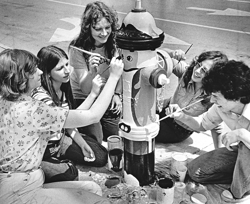 PLUGS GO PATRIOTIC - A number of city fire hydrants are being painted to resemble Revolutionary War patriots as a "plug" for the bicentennial, the project being sponsored by the education committee of the Mahoning-Youngstown Bicentennial Commission.  The artists are (left to right) Terri Prezioso, Janey Martinko, Mary Hulme, Lyn O'Neil, and Rick Schilling.  Miss. Hulme, who supervised the job, is a daughter of MR. and Mrs. Ed Hulme.  Hulme is bicentennial chairman.  The painters are students of William Diana, art instructor at Cardinal Mooney High School.  Paint for the seven-color "patriots" was donated by the O'Brien Corp. through its local distributor, Youngstown Paint & Glass Co.

Photo by Paul R. Schell