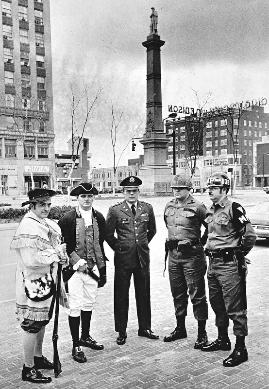 MINUTEMEN - March is "Minutemen Month" for the National Guard, and one step in the observance took place when minutemen of yesteryear and today met at Federal Plaza to do some military jawing.  Left to right are: Joseph Alessi, commander of the American Revolution Colonial Brigade, formed here in connection with the bicentennial observance; Raymond Moore, brigade quartermaster; Capt. Walter Duzzny, public information officer of the Ohio National Guard's 437th Military Police Battalion; Sgt. Kenneth Hoffman, 838th MP company and Sgt. Michael Kobitza also of the 838th.

Photo published March 3, 1975.