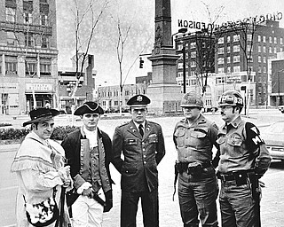 MINUTEMEN - March is "Minutemen Month" for the National Guard, and one step in the observance took place when minutemen of yesteryear and today met at Federal Plaza to do some military jawing.  Left to right are: Joseph Alessi, commander of the American Revolution Colonial Brigade, formed here in connection with the bicentennial observance; Raymond Moore, brigade quartermaster; Capt. Walter Duzzny, public information officer of the Ohio National Guard's 437th Military Police Battalion; Sgt. Kenneth Hoffman, 838th MP company and Sgt. Michael Kobitza also of the 838th.

Photo published March 3, 1975.