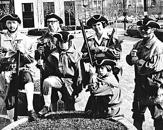 MUSKETS IN HAND - Members of the newly-organized Mahoning Valley Colonial Brigade, costumed and bearing muskets, paraded through the Youngstown Federal Plaza Saturday in observance of George Washington's "real" birthday.  Participating were Jim Caylor (seated) and (from left standing) Howard F. Sarver, Howard P. Sarver, John Caylor, William J. Sarver Jr. and William J. Sarver Sr.

Photo published February 23, 1975.