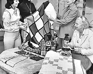 ARTISTS WITH NEEDLES - A Liberty Bell hooked rug, colorful afghan, patchwork quilt, needlepoint tote bag, and calico chain and doll are admired by (left to right) Mrs. Robert Anderson, bazaar chairman; Mrs. David Starkey, Mrs. William W. Hanks, chairman of the bicentennial workshop, and Mrs. Steward Hume, chairman of the Women's Association of First Presbyterian Church.

Photo by Paul R. Schell.