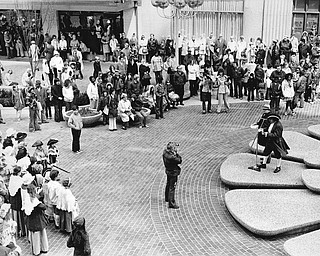 RE-ENACT START OF AMERICAN REVOLUTION AT FEDERAL PLAZA - Clingan Jackson (right foreground), chairman of the Mahoning-Youngstown Bicentennial Commission, and Merv Jones (at microphone on Jackson's left), WKBN Broadcasting Co. production director, discussed the historical importance of Paul Revere's famous ride with area residents Saturday in Youngstown Federal Plaza.  Jackson noted many historians date the start of the American Revolution from Revere's ride, which occurred on April 18, 1775, and Jones read "The Midnight Ride of Paul Revere" by Longfellow.