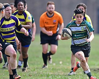 YOUNGSTOWN, OHIO - APRIL 14, 2018: Elaina Ruiz, green, runs with the ball in the open field field avoiding defenders during a rugby match, Saturday morning in Youngstown. DAVID DERMER | THE VINDICATOR