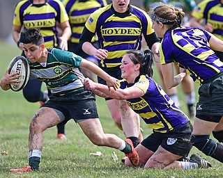 YOUNGSTOWN, OHIO - APRIL 14, 2018: Elaina Ruiz, green, runs with the ball while being tackled from behind by a defender during a rugby match, Saturday morning in Youngstown. DAVID DERMER | THE VINDICATOR