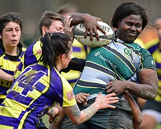 YOUNGSTOWN, OHIO - APRIL 14, 2018: Alina Withers, green, protects the ball while being hit by Sydny Burhart, yellow, during a rugby match, Saturday morning in Youngstown. DAVID DERMER | THE VINDICATOR