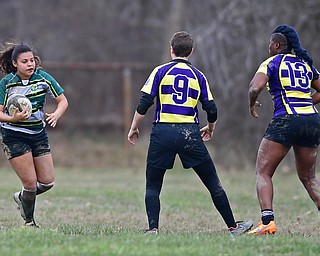 YOUNGSTOWN, OHIO - APRIL 14, 2018: Kiya Miller, green, runs with the ball while Kayla Beaty, left, and Jazmyne Spear, right, yellow, break down for a tackle during a rugby match, Saturday morning in Youngstown. DAVID DERMER | THE VINDICATOR