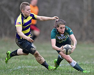 YOUNGSTOWN, OHIO - APRIL 14, 2018: Hannah Hall, green, dives in the end zone to score beating Amy Hale, yellow, during a rugby match, Saturday morning in Youngstown. DAVID DERMER | THE VINDICATOR