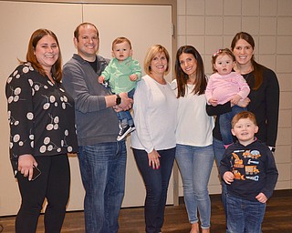 A family of generations: Every person in this photo either a second, third, or fourth generation Holocaust survivor.  From left to right, they are: Katie Kinast, 3rd generation; Ian Anderson, 3rd generation holding Jack Anderson, 4th generation; Terri Anderson, 2nd generation; Morgan Anderson, 3rd generation; Molly Kay, 4th generation, being held by mom Rachel Kay, 3rd generation; and Ethan Kay, 4th generation.  They gathered at the Jewish Community Center for a Shoah Memorial Ceremony Sunday, April 15, 2018.

Photo by Scott Williams - The Vindicator