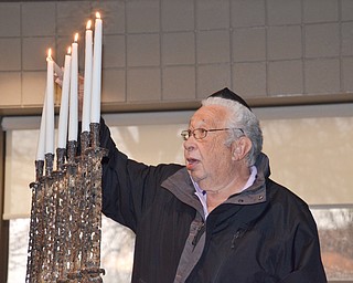 Sam Kooperman, a 2nd generation Holocaust survivor, lights one of six candles, each one representing one million of the six million lost during the Holocaust, at a Shoah Memorial Ceremony held at the Jewish Community Center on Sunday, April 15, 2018.  

Photo by Scott Williams - The Vindicator