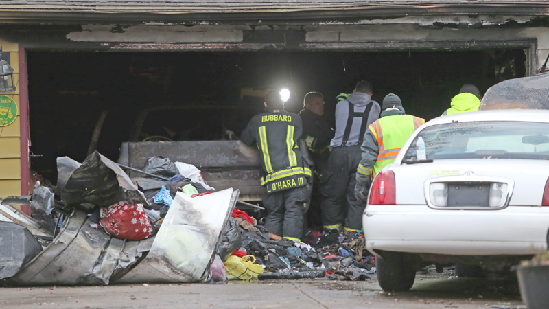 Firefighters and Ohio State Fire Marshals sort through the remains of the gutted garage in the 400 block of Simler Street in Hubbard on Nov. 22. James Vint died of smoke inhalation after becoming trapped in the garage. There is still no cause for how the fire started.