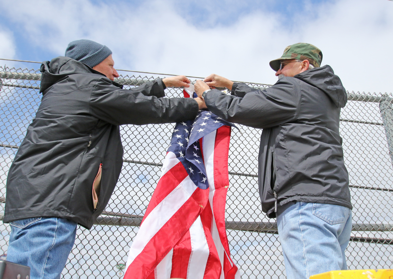 Robert Pluchinsky, of Poland, an HOF military award winner, and Mike Sudzina, both of Mahoning County Veterans Service, were busy Wednesday putting up flags on several bridges in Mahoning County. The three bridges are state Route 46 overpass in Austintown over interstates 80 and 76; Mahoning Avenue over state Route 11 and state Route 164.