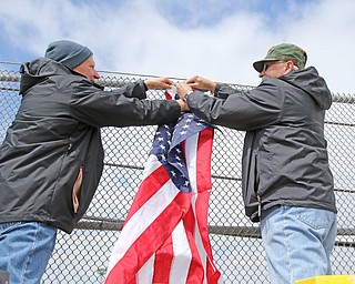 Robert Pluchinsky, of Poland, an HOF military award winner, and Mike Sudzina, both of Mahoning County Veterans Service, were busy Wednesday putting up flags on several bridges in Mahoning County. The three bridges are state Route 46 overpass in Austintown over interstates 80 and 76; Mahoning Avenue over state Route 11 and state Route 164.