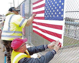 Jerome Givens and Kenny.Jakubek, both veterans, put up hang one of several bridges in Mahoning County. Three bridges are slated to get the flags. They are the state Route 46 overpass in Austintown over interstates 80 and 76; Mahoning Avenue over state Route 11 and state Route 164.