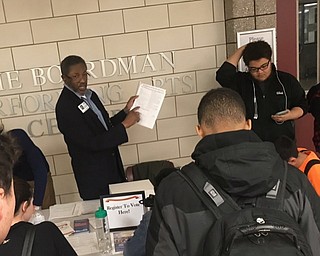 Neighors | Submitted .Board of Elections Secretary Raymond Butler helped students register to vote at Boardman High School on March 14. More than 90 students registered to vote.  .
