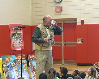 Neighbors | Zack Shively.Children's author Tim Smith explained to students at Austintown Elementary why he loves paper, stemming from his drawings while in timeout as a child. He demonstrated a way paper could be used to make a cup in the wild. Pictured, he poured water into his cup he made from a sheet of paper and took a sip.