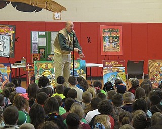 Neighbors | Zack Shively.All of Tim Smith's ten "Buck Wilder" books focus on nature, as did much of his presentation. Pictured, he told the students a survival tip to use in the wild: use honey to cover and heal wounds.